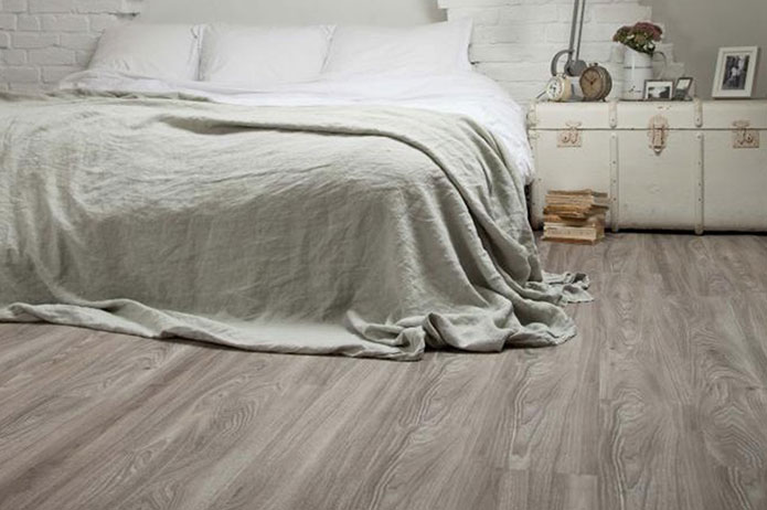 Cozy bedroom featuring Adore flooring