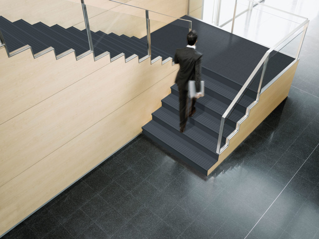 Stairwell image featuring man walking on SmartStep stairwell management system